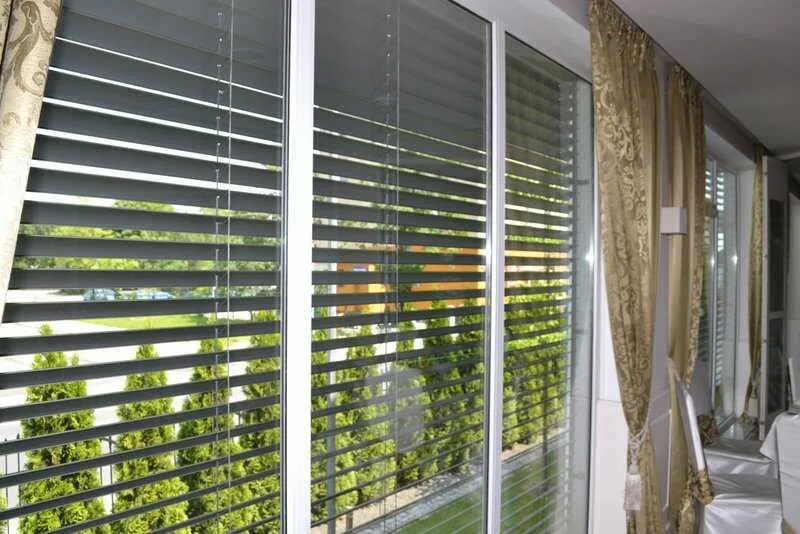 Moderne Raffstores mit Lamellen im Restaurant von NORTA. Effektiver Sonnenschutz und Stil für große Fensterfronten.