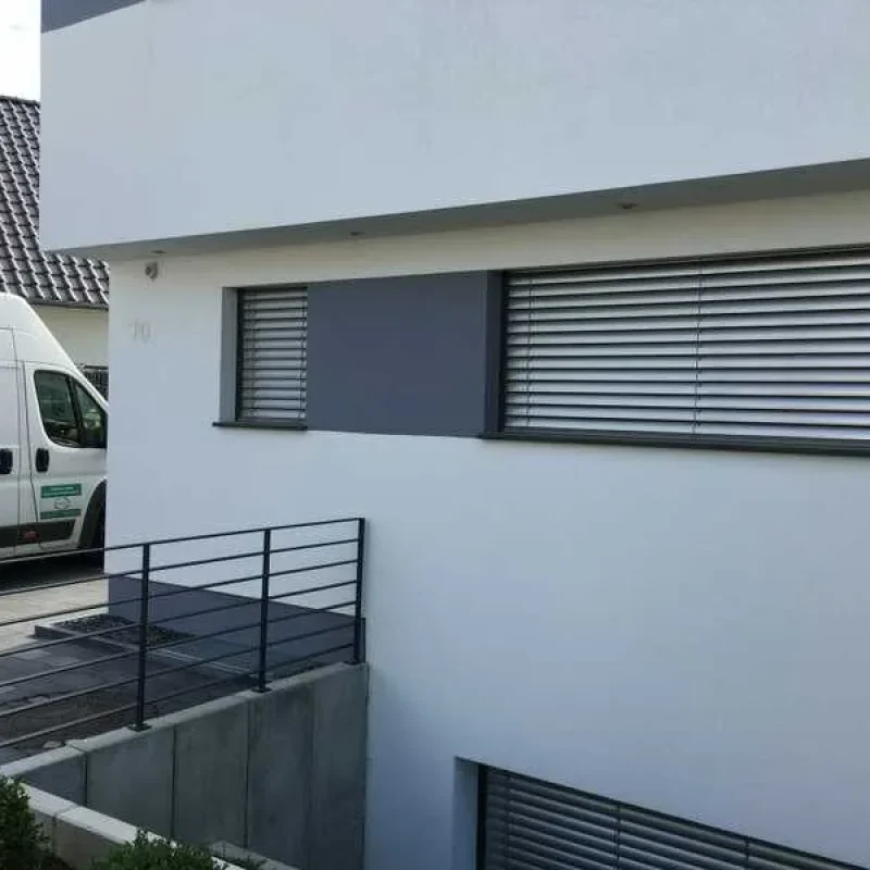 Moderne Raffstoren im Aufsatzkasten an Schüco-Fenstern von NORTA. Effizienter Sonnenschutz und Sichtschutz für Einfamilienhaus.