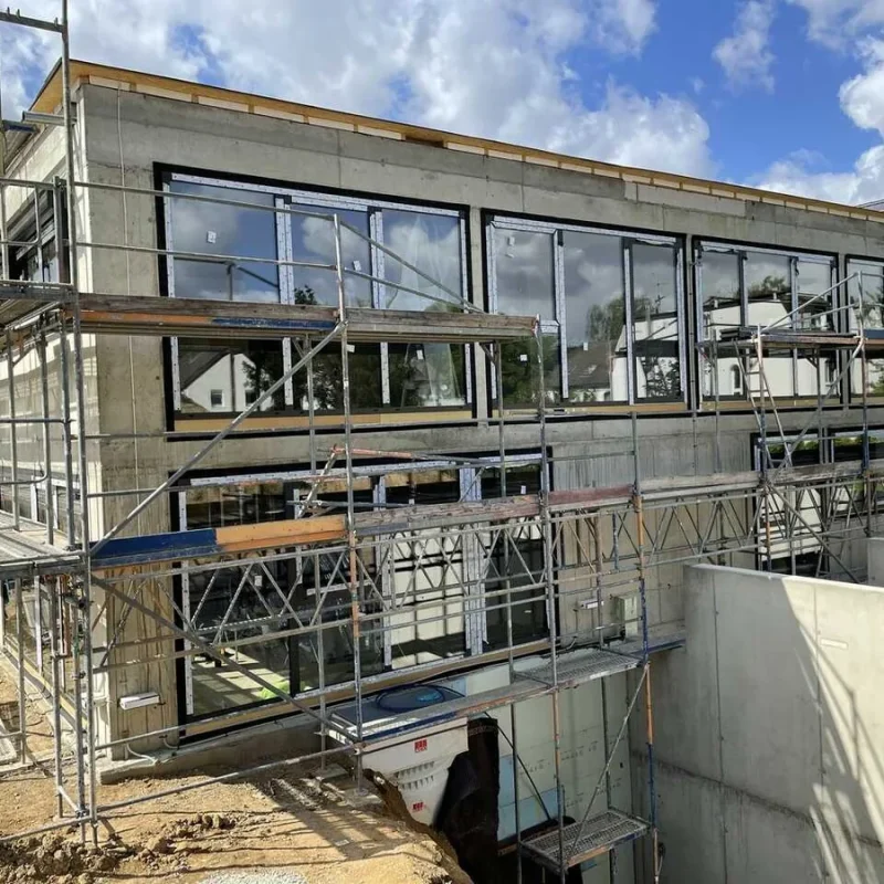 Moderne Fensterinstallation auf einer Baustelle von NORTA. Qualitative Lösungen für effiziente Gebäudeisolierung.