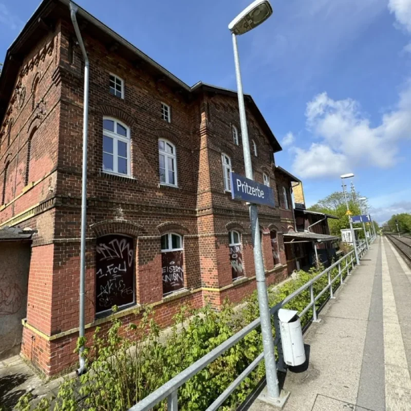 Backsteingebäude mit Holzfenstern in einer ländlichen Umgebung, ideal für hochwertige Wohnlösungen von NORTA.