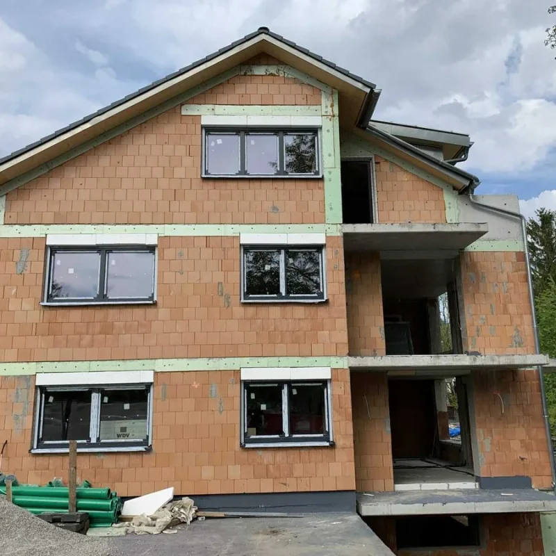 Modernes Haus im Bau mit neuen NORTA Fenstern. Hochwertige Fensterlösung für optimale Isolierung und Energieeffizienz.